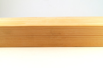 A wooden surface of a planed board on a white background.