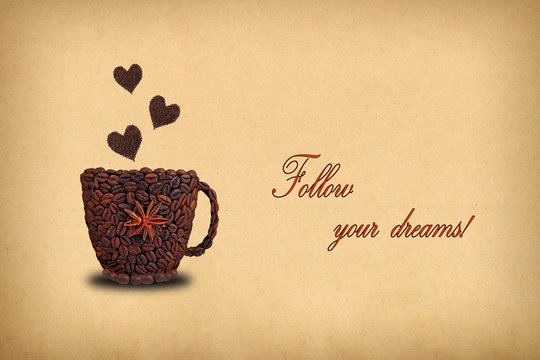 Fototapeta Creative concept photo of a cup of coffee and hearts  made of coffee beans.  Inscription "Follow your dreams!"