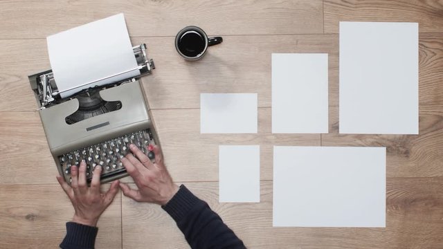 Book writing by the window with a vintage typewriter. 4K video colors and black and white
