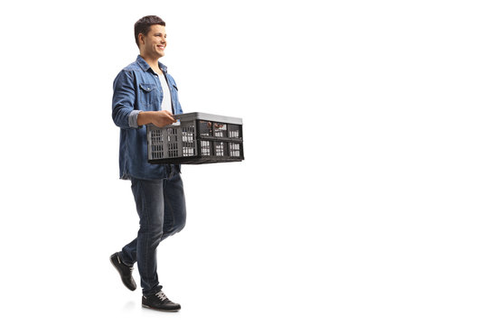 Young Guy Holding An Empty Plastic Crate And Walking