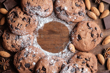 Chocolate chips cookies on dark rustic texture with copy space for your text. Top view.