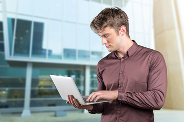 Young caucasian man with portable pc in his hands