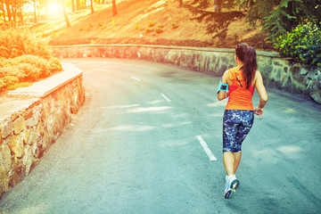 woman running around in the park in the morning