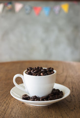 Coffee Cup or Coffee Beans on wooden table in the coffee shop