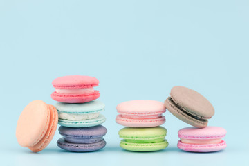 Fototapeta na wymiar Sweet French macaroons cake (or macarons) with vintage pastel colored tone on pink background.