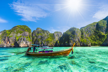 Traditional long tail boat on most beautiful famous Maya Bay on Phi Phi Islands, Thailand - obrazy, fototapety, plakaty