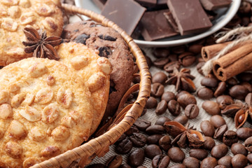 Chocolate chips cookies and peanut cookies in wicker basket. Close-up view.