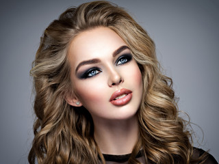 Closeup face of a beautiful girl with  makeup in style smoky eyes.