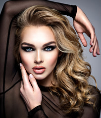 Closeup face of a beautiful girl with  makeup in style smoky eyes.