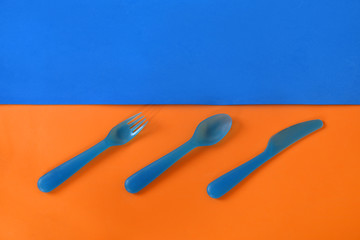Cutlery on a blue-orange background. Dishes