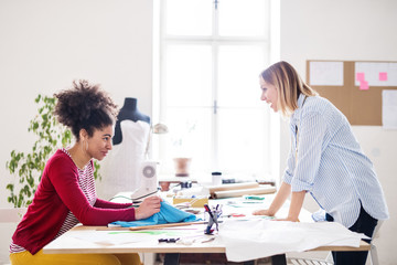 Obraz premium Young creative women in a studio, startup business.