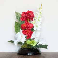 Beautiful floral composition with artificial flowers. An interior decoration.