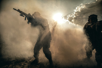 United States Marines in action. Military equipment, army helmet, warpaint, smoked dirty face,...