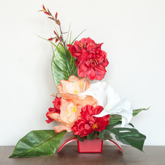 Beautiful floral composition with artificial flowers. An interior decoration.