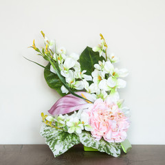Beautiful floral composition with artificial flowers. An interior decoration