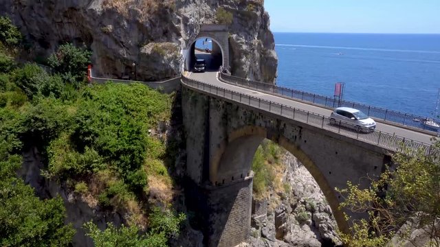 car driving on famous picturesque road viaduct over sea of Amalfi coast, Italy