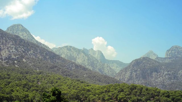 Turkey - August 2017, Kemer, Beldibi: Forest in foot of the mountains on blue sky background. Tropical summer landscape