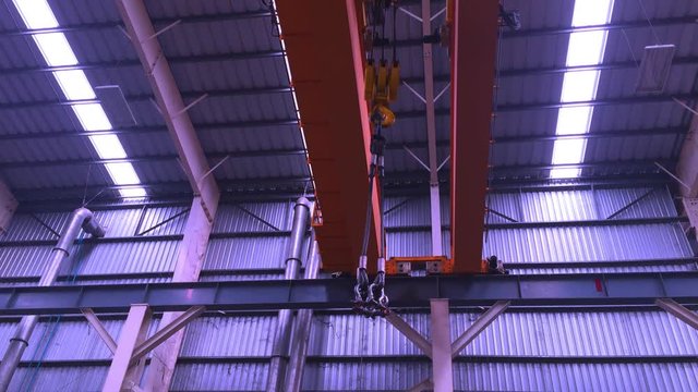 4K video for industry and manufacturing concept from yellow heavy and big crane move and work on metal bar 