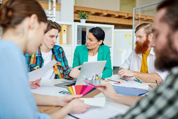 Group of designers planning new project together. They are working with color samples