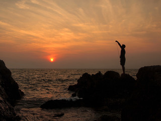 fishermen silhouette at sunset