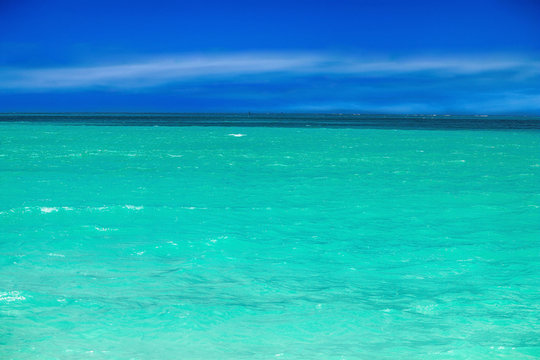 Panorama of the ocean with beautiful water colors and blue sky
