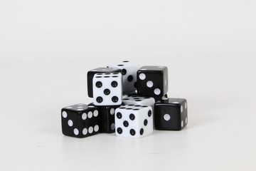 a heap of black and white dices are lying in the studio