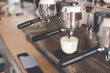 The coffee machine makes espresso, which drips slowly into the Cup