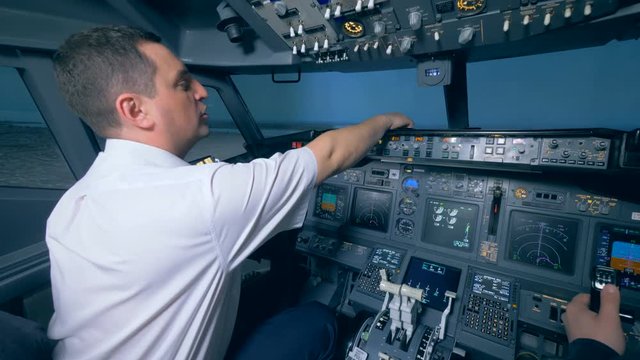 One pilot points to the runway, sitting at the helm.