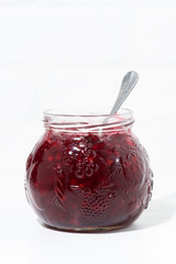 jar with cowberry jam on white background, vertical