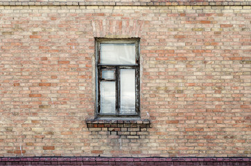 Window in the brick wall of an old building. The picture was taken in Russia, in the city of Orenburg. 04/07/2018