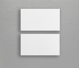 Mockup of two horizontal business cards at grey paper background.