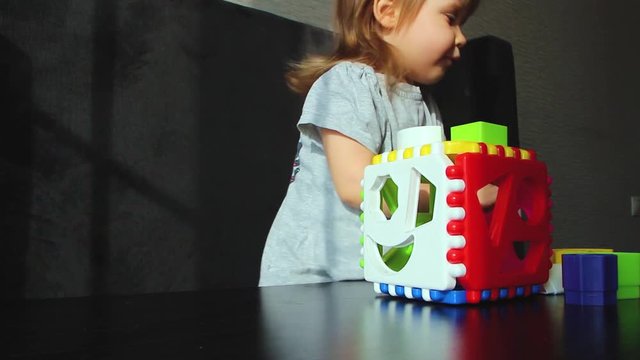 little girl plays in the sorter