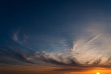 Fototapeta premium Dramatic sunset sky with orange colored clouds.