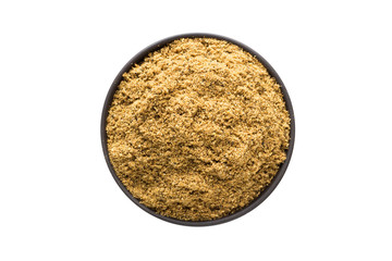 Cumin powder in clay bowl isolated on white background. Seasoning or spice top view