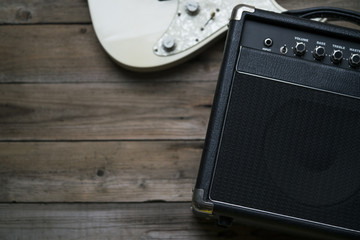 Obraz premium Guitar amplifier and a electric guitar on wood table