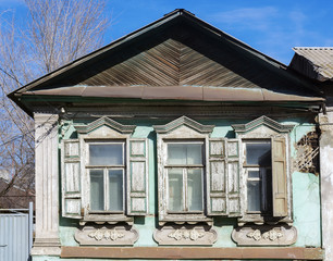 The facade of an old dilapidated house. The picture was taken in Russia, in the city of Orenburg