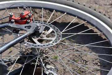 Brake on a bicycle, wheels and knitting needles close-up