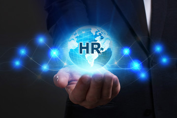 Business, Technology, Internet and network concept. Young businessman working on a virtual screen of the future and sees the inscription: HR