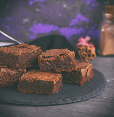chocolate pieces of brownie on a black graphite plate