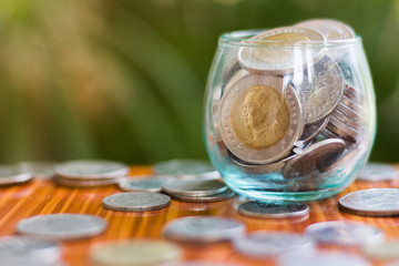 Coin in glass bottle with money stack step up growing growth saving money, Concept financial business investment.