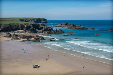 Surfers on a beach in Cornwall England