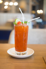Iced tea with lemon, cherry and mint