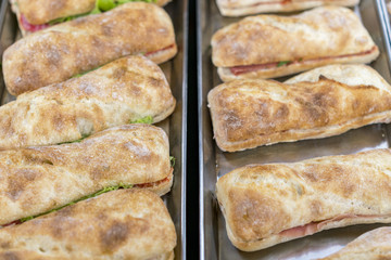 hamburger with bacon and herbs in several rows. On an iron tray