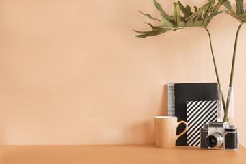 Creative desk with copy space. Empty pastel wall. Minimalistic concept.