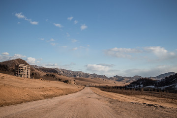 Sand road track outside country with mountain and blue sky