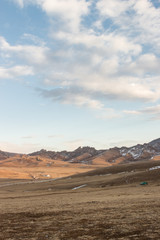 Fototapeta na wymiar View of land, mountain and cloudy sky outside the city of Ulaanbaatar, Mongolia
