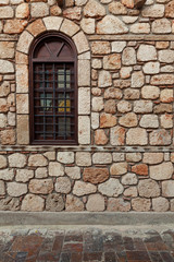 Fototapeta na wymiar Window on old stone wall