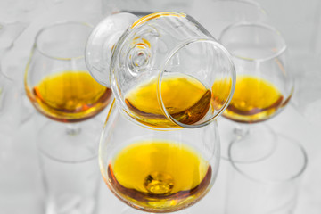 Glasses are filled with whiskey on the table
