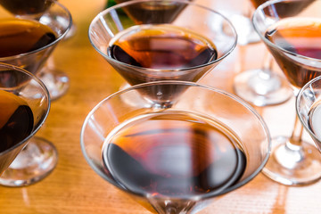 Alcoholic cocktails on a glass surface, banquet table.