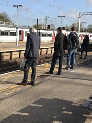 Commuters waiting at the station for a train